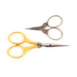 Two pairs of French scissors, comprising an early 19th Century pair with short steel blades to