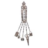 A good Victorian silver chatelaine, the hook with two piece leaf scroll mount to three panel form