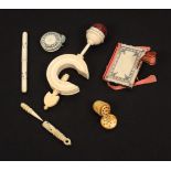 Six 19th Century ivory Madras sewing tools with burnt circle decoration, comprising a pin cushion
