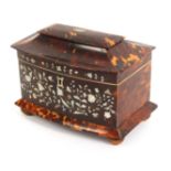 A Victorian bow front tortoiseshell tea caddy, the pagoda style top divided by pewter lines, the