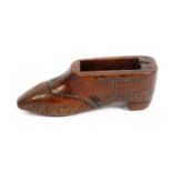 A late 18th Century or early 19th Century elaborately decorated snuff shoe in fruitwood, lacking the