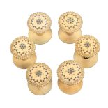 A fine set of six early 19th Century ivory reels, Madras, the tops of domed form with burnt circle