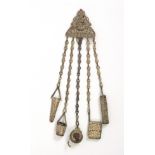 A late 19th Century plated brass chatelaine, the pierced triangular clip mount with Roman head and