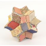 A pin stuck patchwork pin holder in the form of a hexacontagon, in coloured silks with pin stuck
