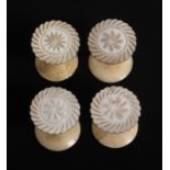 A set of four reels, the mother of pearl tops with cut flower head tops on bone stems and bases, 2.