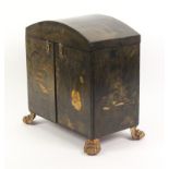 A Regency chinoiserie lacquer sewing cabinet, the black ground decorated in gilt, the arched