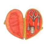 A mid 19th Century miniature sewing set for a child or doll, contained in a natural shell, the