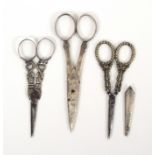 Three pairs of 19th Century scissors, comprising a steel pair encased in engraved silver, slight