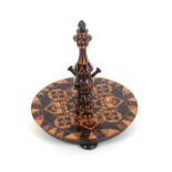 An attractive Tunbridge ware rosewood ring stand, the circular base on three turned feet and