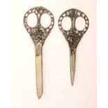 Two pairs of early 20th Century Italian steel scissors, comprising a pair with oval loops within