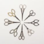 Eight pairs of silver mounted continental steel scissors, all with decorative arms and loops to