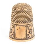 An attractive rose gold thimble probably American, the frieze engraved with flowers and leaves