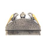 A 19th Century silver and gilt ethnic comb, the floral engraved arched mount below a lidded vase and