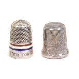 Two thimbles, comprising a silver and red, white and blue enamel example engraved ‘A Stitch For