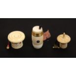 Three 19th Century tape measures, comprising an ivory barrel form example with gilt band, steel boss