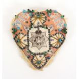 A large format regimental pin cushion, for the Devonshire Regiment, pink silk ground with cap