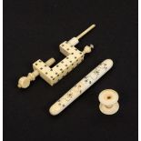 A 19th Century ivory clamp and a cylinder needle case, each with burnt circle decoration, the