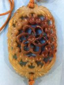 A pierced fretwork and carved jade pendant