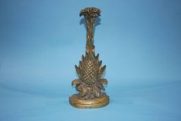 A brass pineapple door stop