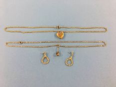 A 9ct gold heart pendant, a 9ct gold mounted pendant together with two yellow metal chains and a