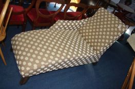 A modern polka dot chaise, in beige and cream