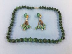 A Malachite beaded necklace and a pair of earrings