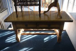 An oak two drawer coffee table