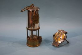 An Eccles Miners lamp and an AA badge