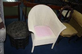 A cream Lloyd Loom chair and carved occasional table