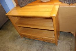 A pale oak three drawer bookcase