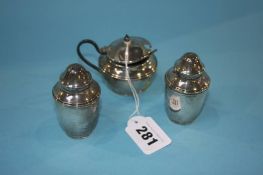 A silver three piece cruet set