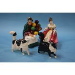 A Royal Doulton figure 'The Old Balloon Seller', a Doulton figure and two cats (4)