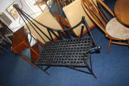 A metalwork two seater bench