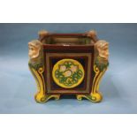 A large ceramic Majolica style jardiniere, decorated with a monkey head to each corner. 43 cm wide x