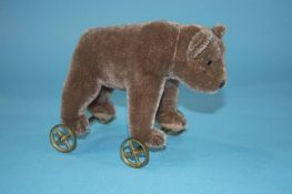 A Steiff brown bear on wheels