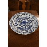 A very large Oriental blue and white charger, the centre decorated with a fish, 59 cm diameter
