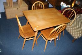 An Ercol Golden Dawn table and four hoop back chairs