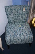 A pair of bedroom chairs with blue upholstery and white floral designs