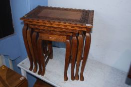 An Oriental carved nest of tables