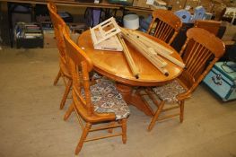 An oak circular table and four chairs