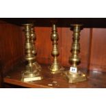 Two pairs of brass candlesticks