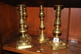 Two pairs of brass candlesticks