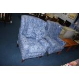 A pair of blue deep easy armchairs