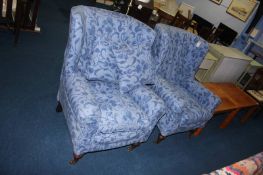 A pair of blue deep easy armchairs