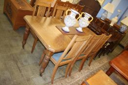 Oak extending dining table and six chairs