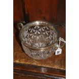 A clear glass fruit bowl, with plated mounts