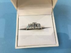 An 18ct white gold ring set with nine small diamonds to each setting, size 'P', 3.3g