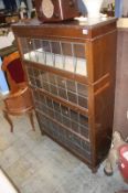 A mahogany globe style four tier stacking bookcase, with leaded glass