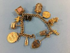 A gold charm bracelet, including a full and a half sovereign, total weight 59g