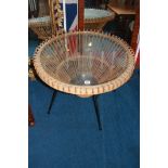 A glass top circular coffee table, with basket weave and metal framework, 68cm diameter